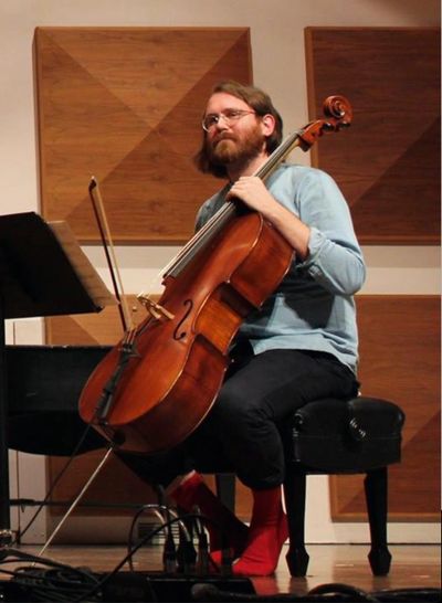 Cory Harper-Latkovich with cello performing at Wilfrid Laurier University in Waterloo, Ontario. 