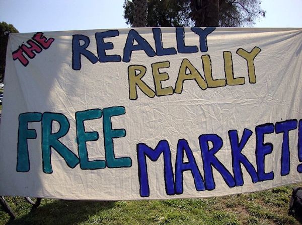 Banner reading 'The Really Really Free Market!' outdoors.