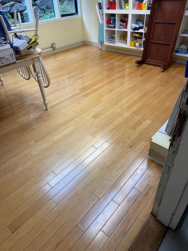 Well-maintained hardwood floor in a craft room.
