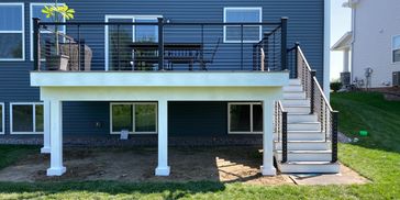 Modern Deck with White Posts and Black Railings for outdoor living. Elegant design. Luxury Deck.