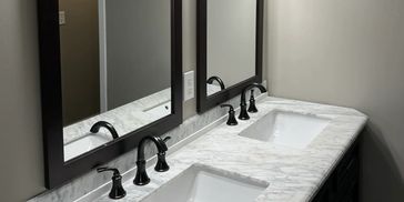 Double Vanity Bathroom- Marble Countertops Dual mirrors, black hardware and elegant design.