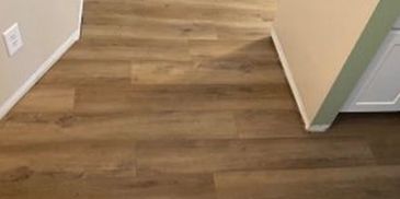 Hardwood Flooring Installation in Northwest MN Suburb with white trim for a timeless look.