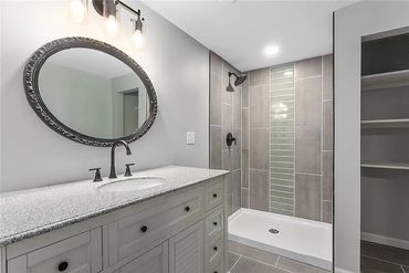 Modern bathroom with a large vanity and walk-in shower.