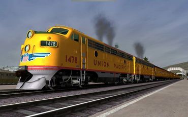 Yellow Union Pacific train stopped at a platform with smoke rising.