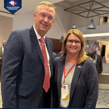 Two professionals smiling at a Texas Veterans Commission event.
