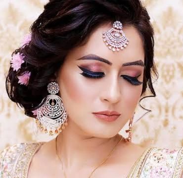 Elegant woman with traditional jewelry and makeup.