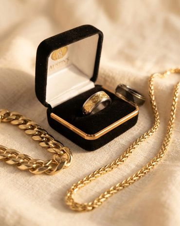 Men's jewelry collection in yellow gold featuring engraved dome band ring displayed in Austin's Fine
