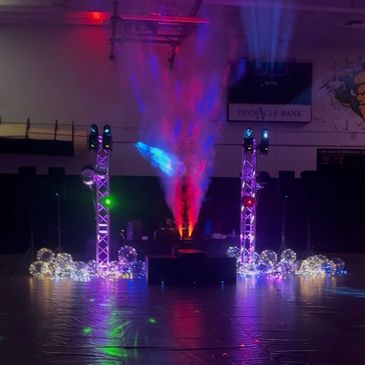 Colorful lights and smoke effects on a stage setup.