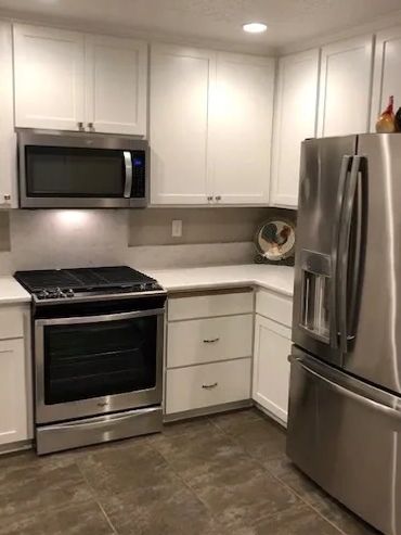 ceiling-height cabinets refinished in white