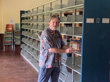 A Volunteer gave two weeks to train and set up the library shelves on two campuses.
