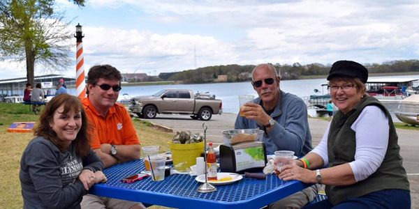 Family and friends enjoying food and drinks at The Grill at Clemson Marina