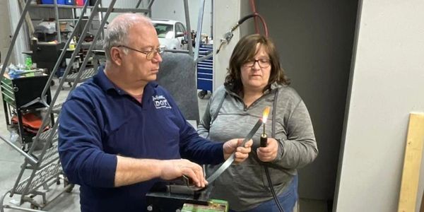 Steve and Mary working on adaptive and assistive technology Switch Hitter parts.