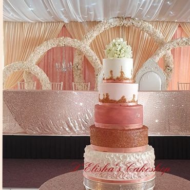 5 tier wedding cake in rose pink theme with petals on the base tier and hydrangea bunch flower toppe