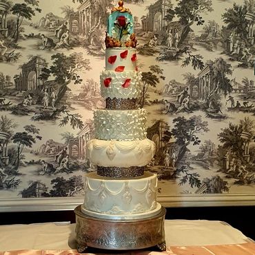 7 tier wedding cake including the separator with beauty and the beast topper.