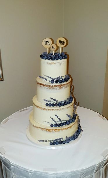 Rustic wedding cake, semi-naked 3 tier wedding cake with blueberries and lavender.