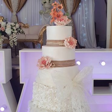 5 tier rustic theme wedding cake with an african exotic native flowers & peony's with petals designe