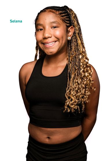 Teen girl with braided hair smiling.
