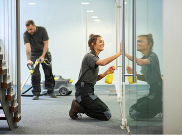 two people are cleaning the area