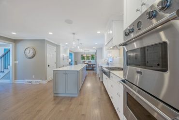 Modern kitchen with stainless steel appliances and a central island.