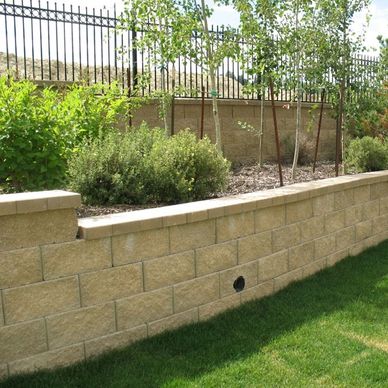 Retaining Wall constructed of stone with planter garden for added appearance