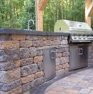 Outdoor kitchen constructed of stone with slate countertops. 