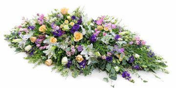 Elegant floral arrangement with pastel roses and purple flowers on white.