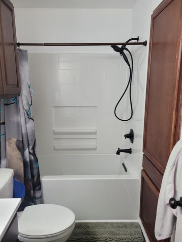 Completed remodel of bathroom, bathtub/shower, and cabinet.