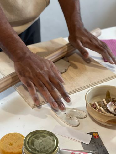 hands rolling clay