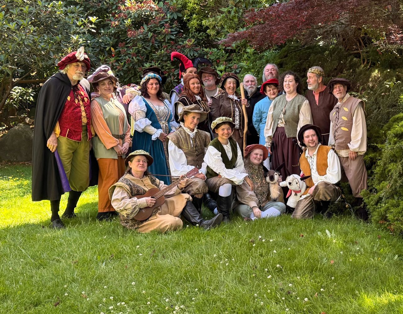 Group in medieval costumes outdoors.