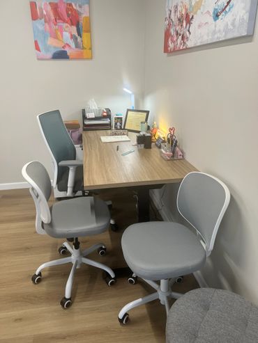 Modern office space with ergonomic chairs and a tidy wooden desk.