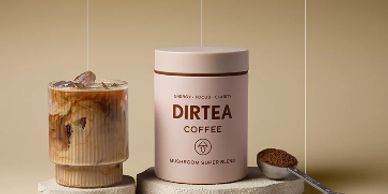 DIRTEA Coffee mushroom superblend with iced coffee and coffee grounds on spoon.