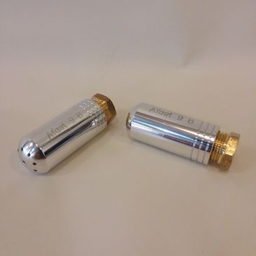 Two shiny metal cartridges with brass bases on a white surface.