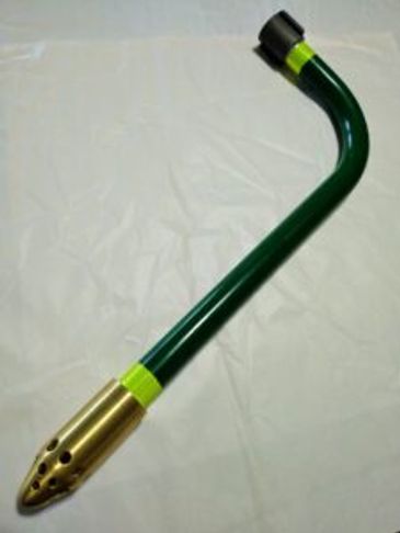 Green and gold curved metal tool with holes.