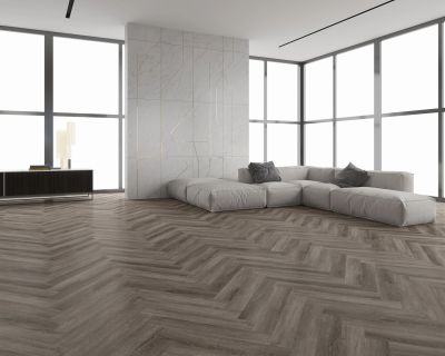 Modern living room with a large gray sectional sofa and Brampton Chase LVT Flooring