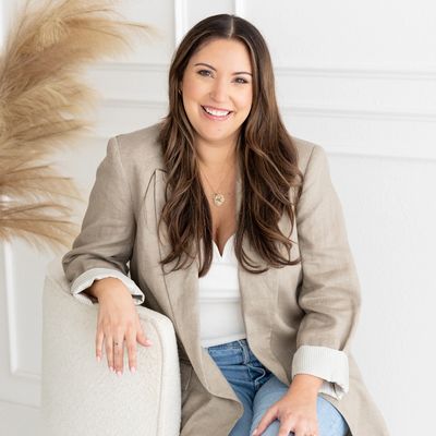Farah Downs, licensed school psychologist specializing in child mental health, seated and smiling.