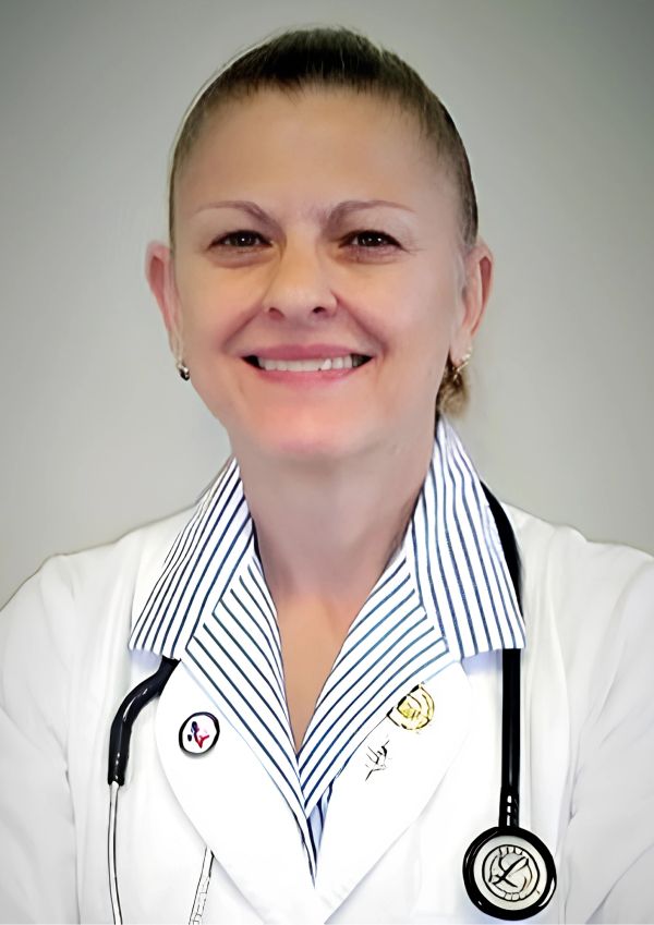 Smiling female doctor in white coat with stethoscope.