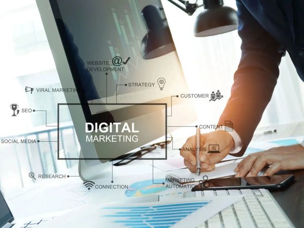 Person working on digital marketing strategy with charts and a laptop.