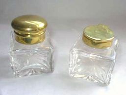 Pair of ink bottles showing the dome and flat flip tops in brass