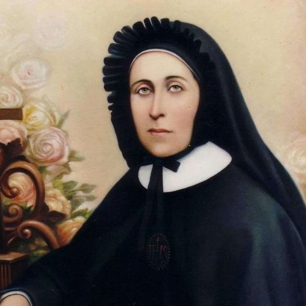 Portrait of a woman in traditional black religious habit with white collar.