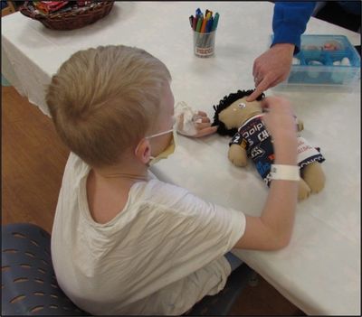 Young boy decorating his medical boy