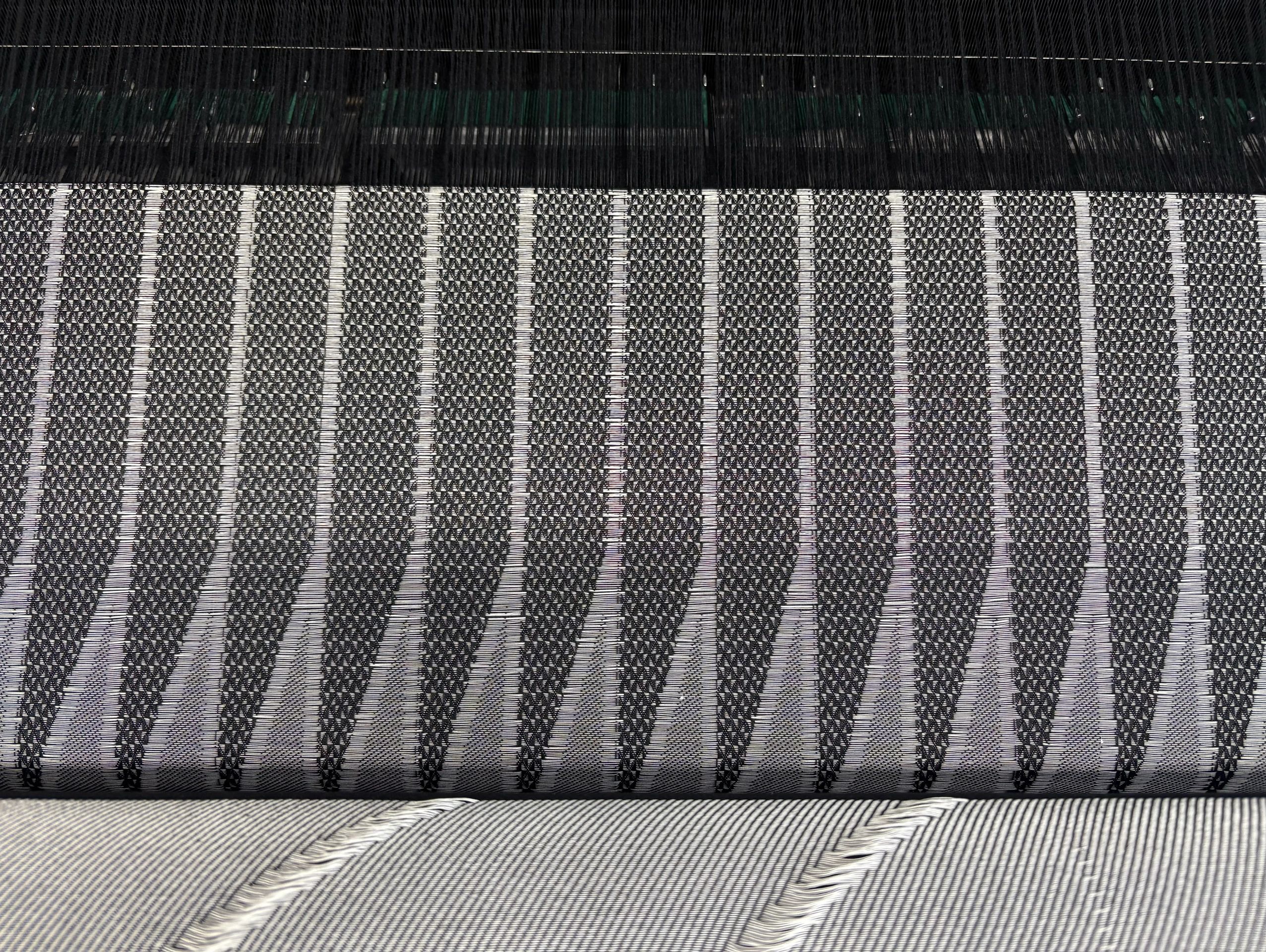 Close-up of intricate black and white woven textile pattern.