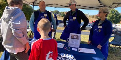 Rotarians talking with visitors to Lake Robinson Day