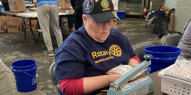 woman sealing a bag at a food packaging event in Mauldin