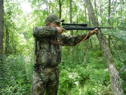 A hunter spot and stalking using a Hip Stick Shooting Rest to support his rear arm with a rifle