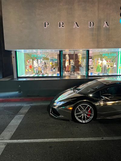 A Lamborghini Huracan in front of Prada store