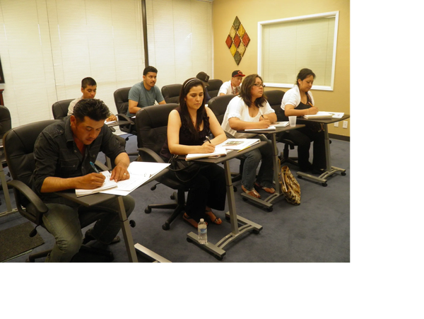 Group of adults students taking notes in a English class.