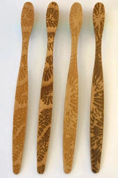 Coral Engraved Bamboo Toothbrushes with rainbow bristles.