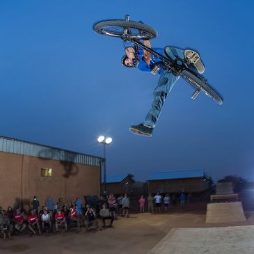 BMX rider jumping a ramp in front of a crowd