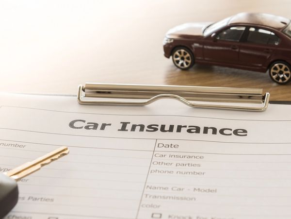 Car insurance form with model car and key.
