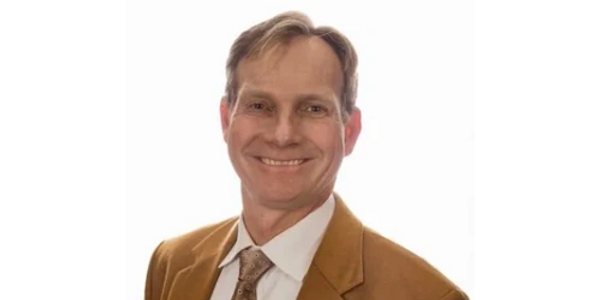 Smiling man in a brown suit. Executive Leadership, Sustainability, Climate Governenace AxVe